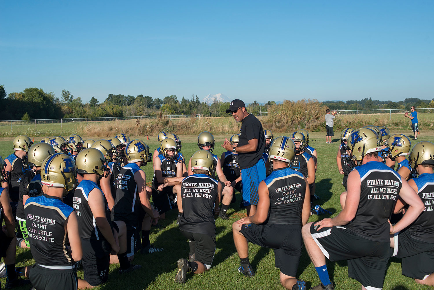 File Photo / The Chronicle.Adna football coach K.C. Johnson addresses his team during a preseason practice in 2016.